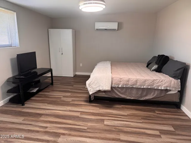 a bedroom with a bed and a flat screen tv