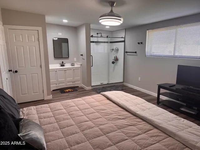 a spacious bedroom with a bed and furniture
