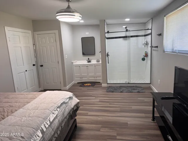 a bedroom with a bed and a flat screen tv