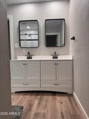 a bathroom with a double vanity sink and mirror