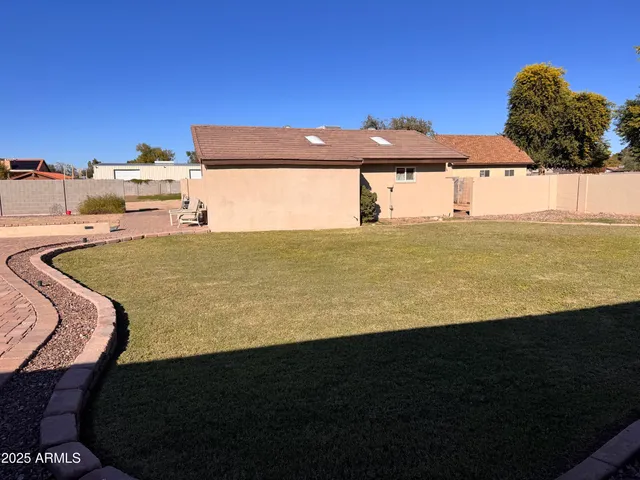 a view of a swimming pool with a yard