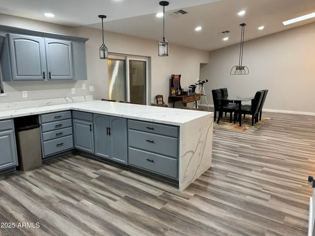 a large kitchen with kitchen island a sink stainless steel appliances and cabinets