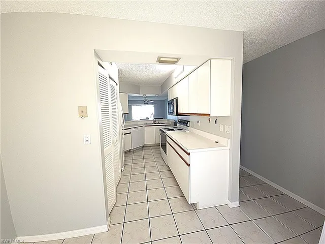 a kitchen with a sink a stove and cabinets