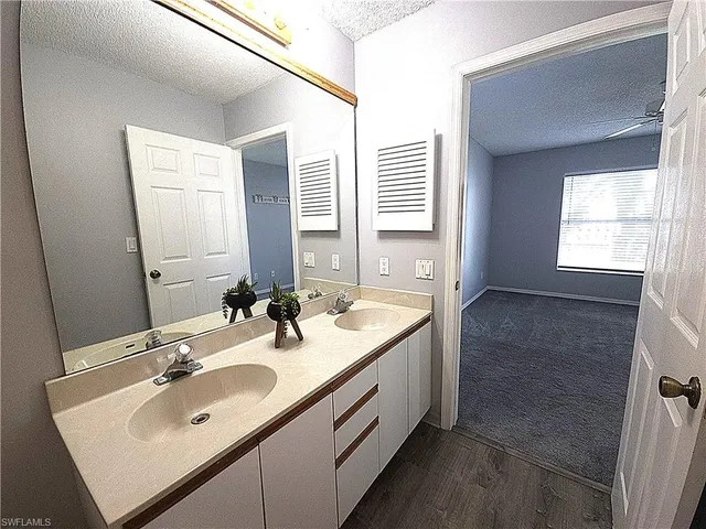 a bathroom with 2 sink and a mirror