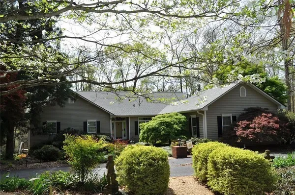 a front view of house with yard and green space