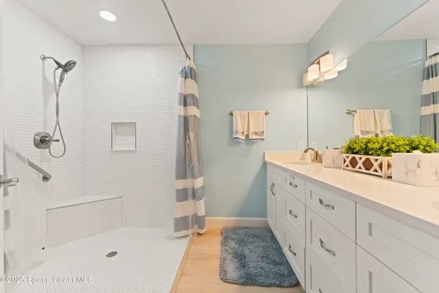 a bathroom with a tub sink and mirror