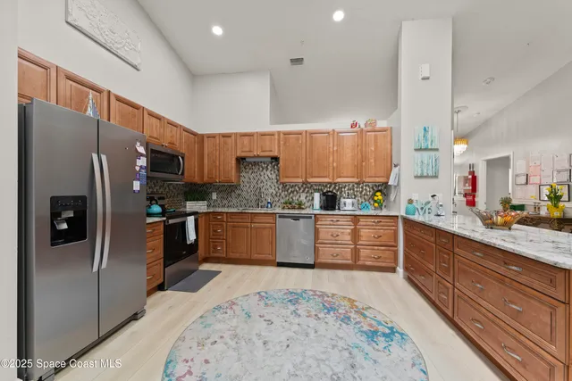 a kitchen with a refrigerator sink and cabinets