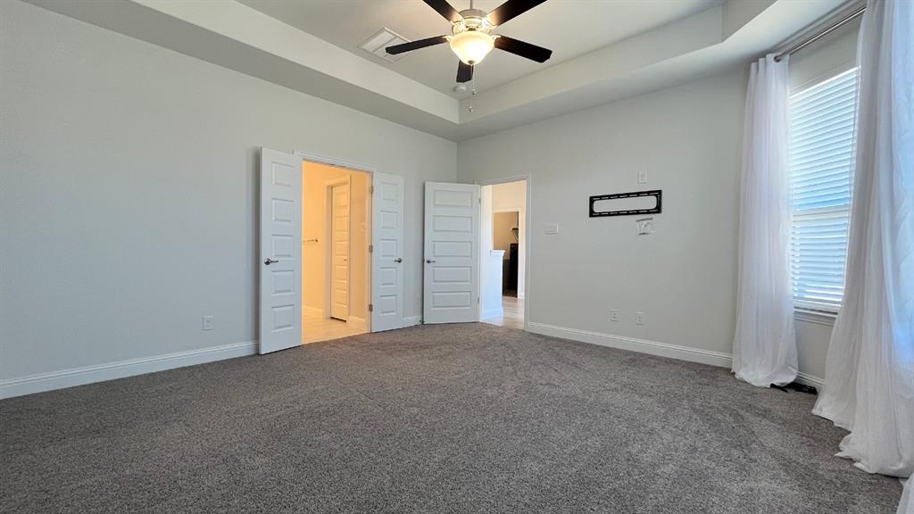5304 Babcock Road McKinney, TX 75071 - Photo 14 of 27 an empty room with chandelier fan and windows