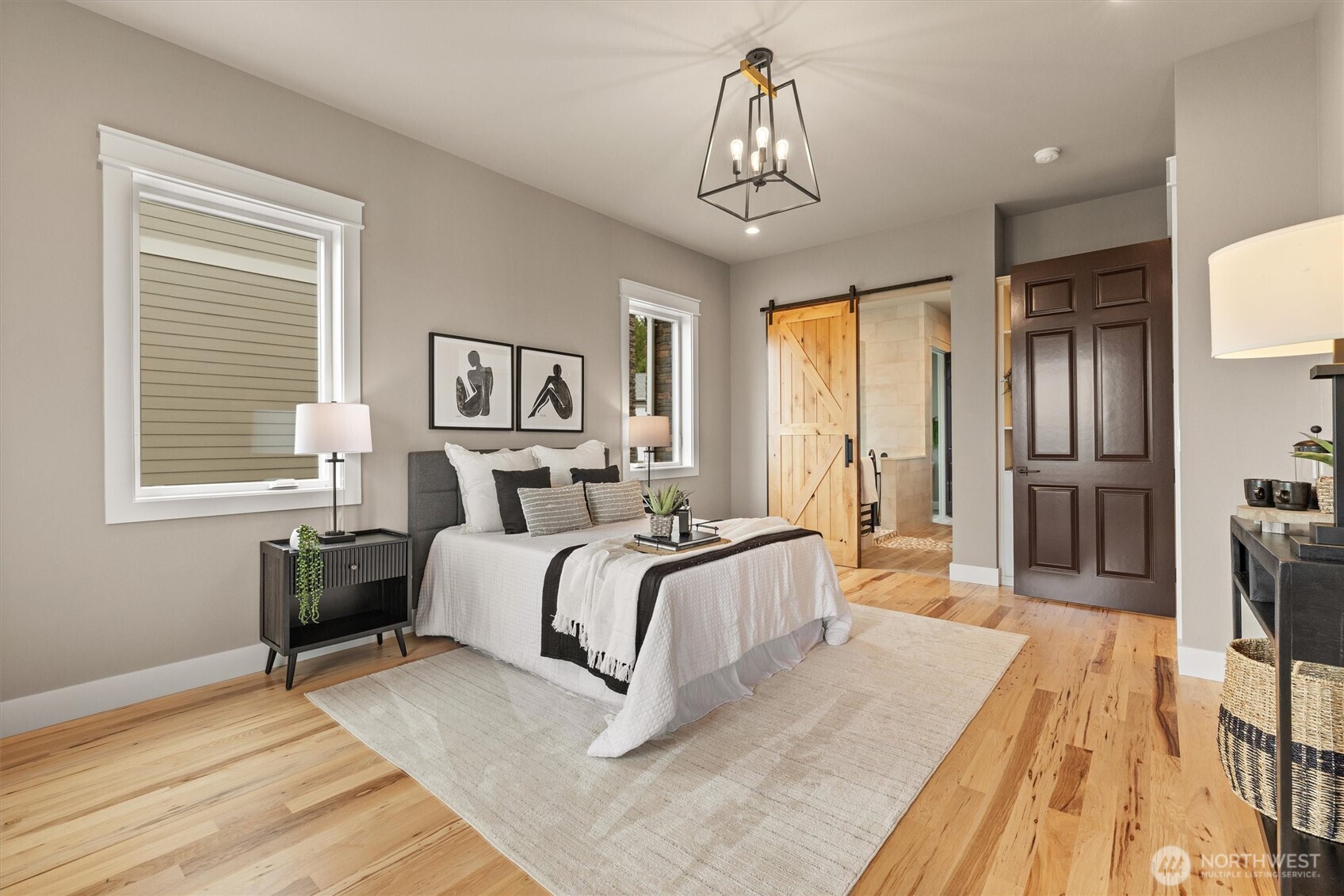 151 East Windy Ridge Lane Belfair, WA 98528 - Photo 18 of 40 a bed room with a bed and a chandelier