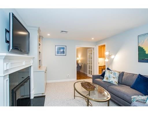 13 Stonybrook Road Medfield, MA 02052 - Photo 11 of 32 a living room with furniture a flat screen tv and a fireplace