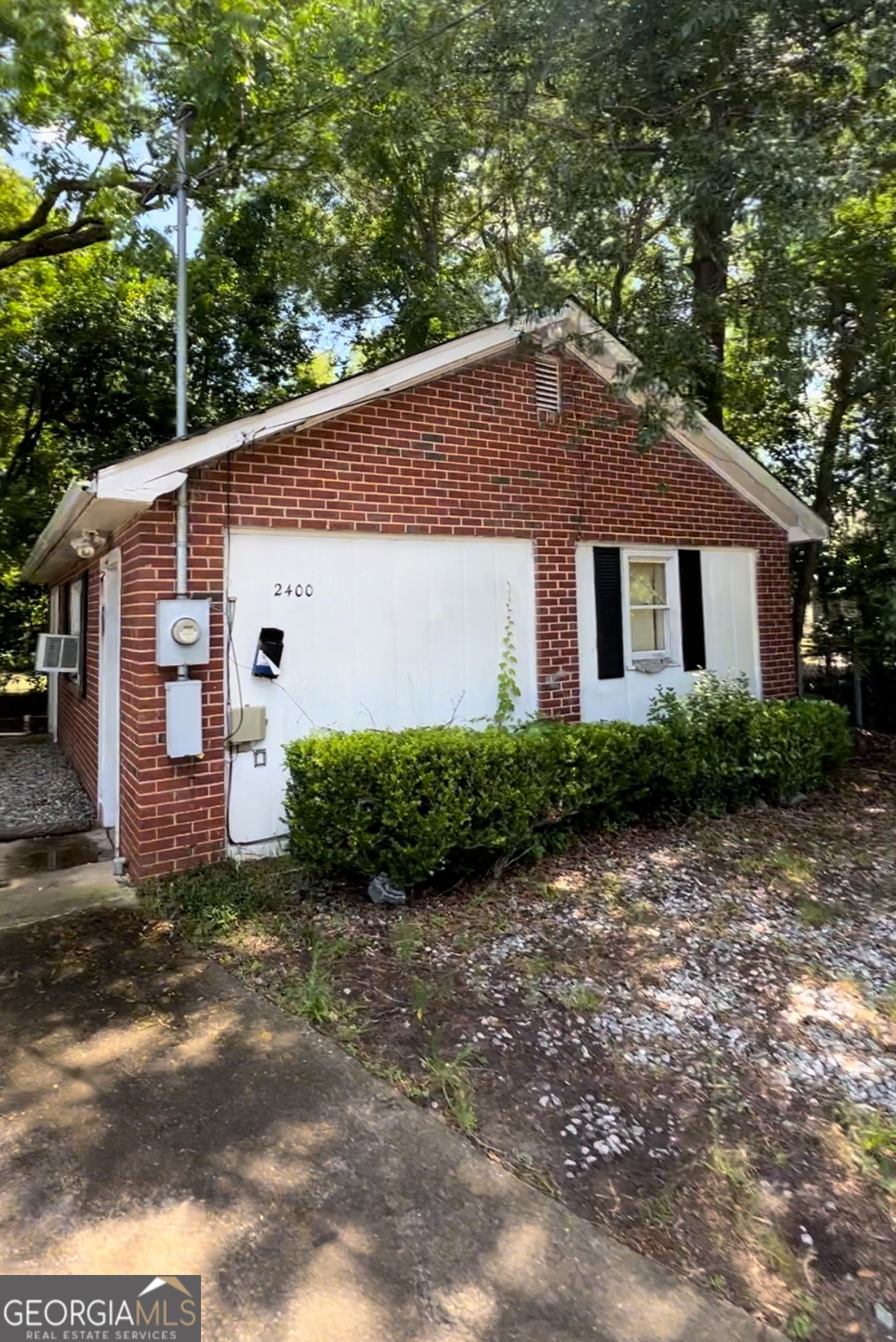 2400 Bell Street Columbus, GA 31906 - Photo 2 of 2 a front view of a house with a yard and garage