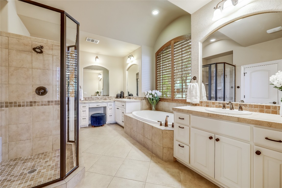 17704 Regatta View Drive Jonestown, TX 78645 - Photo 16 of 38 a large bathroom with a double vanity sink a large mirror and shower