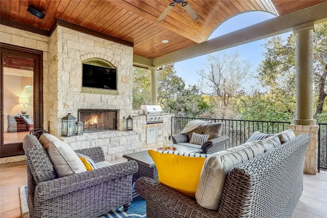 a view of a patio with couches chairs and a fireplace