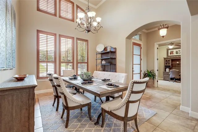 a view of a dining room with furniture and chandelier