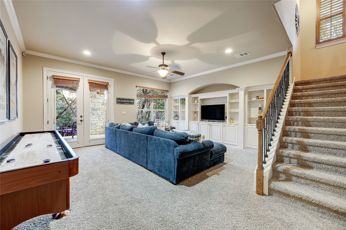 17704 Regatta View Drive Jonestown, TX 78645 - Photo 21 of 38 a living room with furniture and a flat screen tv