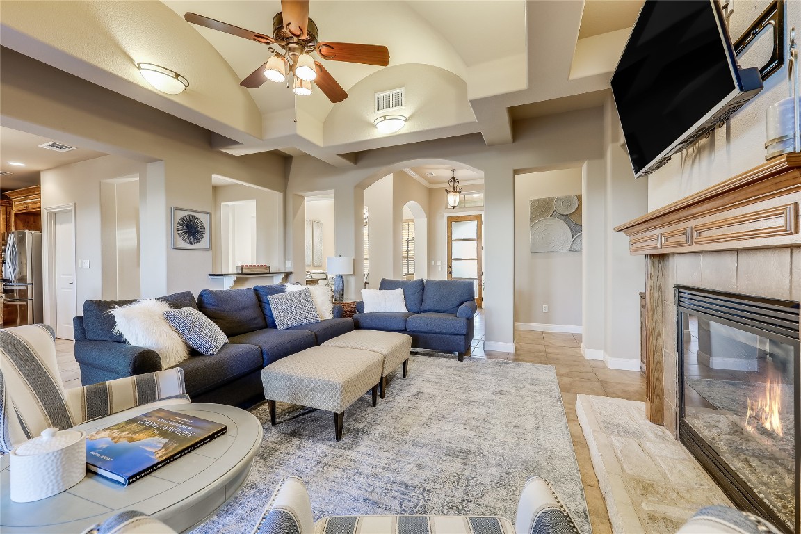 17704 Regatta View Drive Jonestown, TX 78645 - Photo 10 of 38 a living room with furniture a chandelier and a fireplace