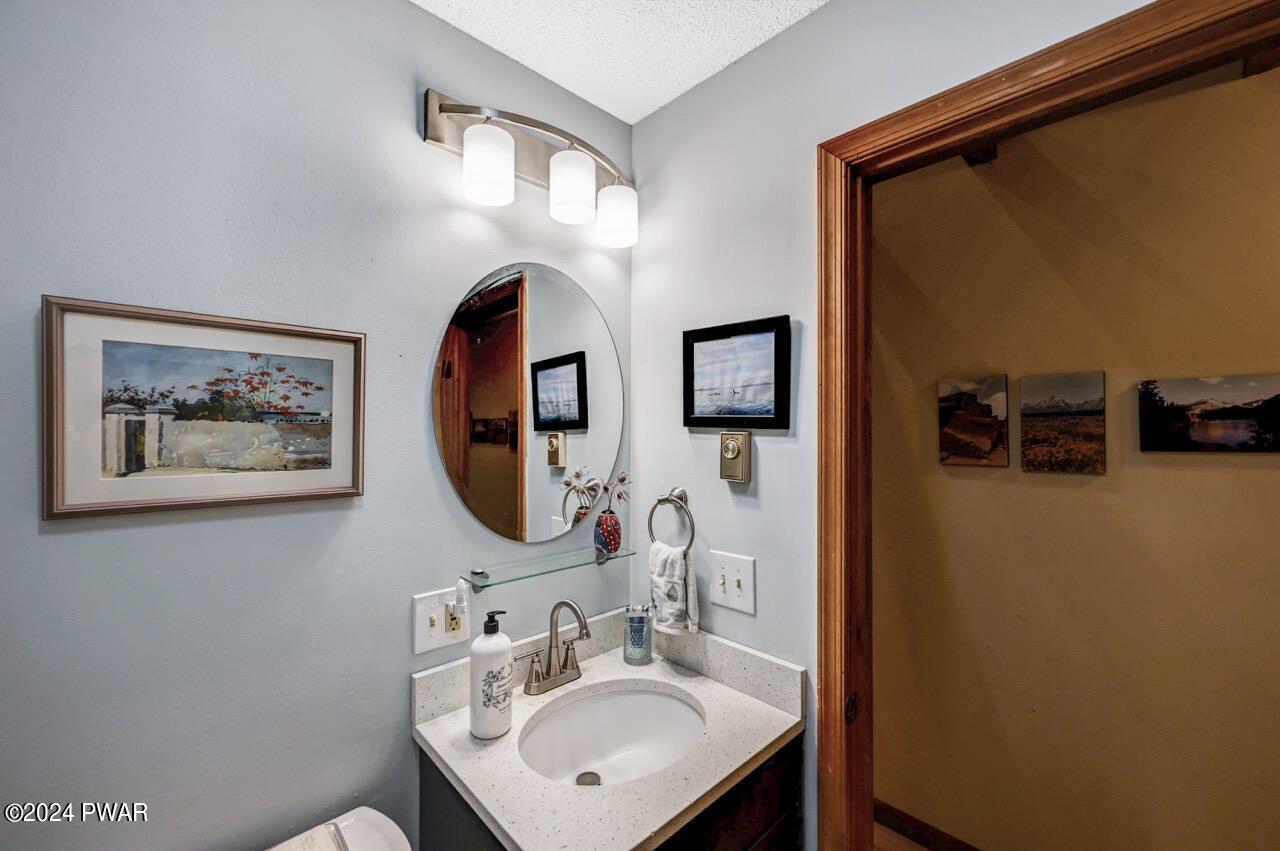 141 Maple Ridge Drive Hawley, PA 18428 - Photo 48 of 84 a bathroom with a sink mirror and vanity