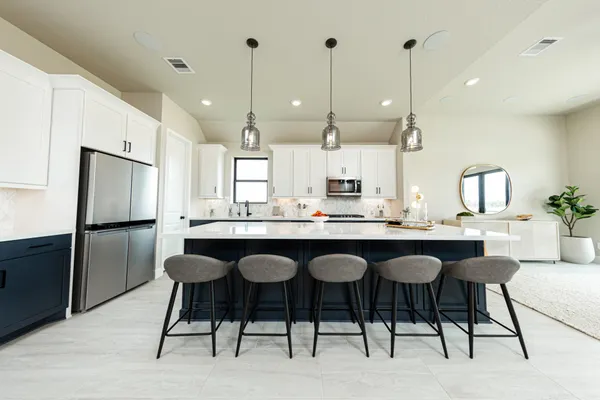 a large kitchen with a table and chairs