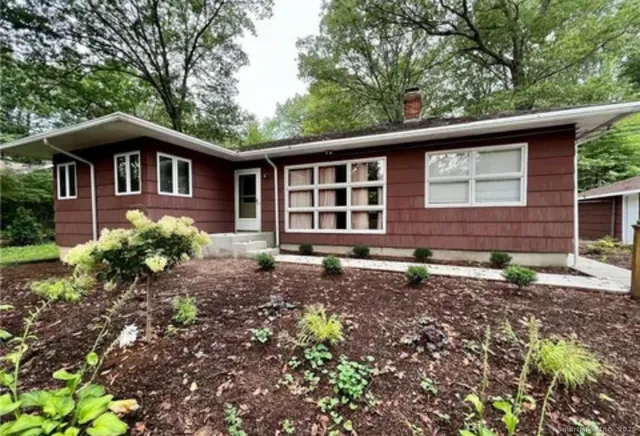 a front view of a house with garden