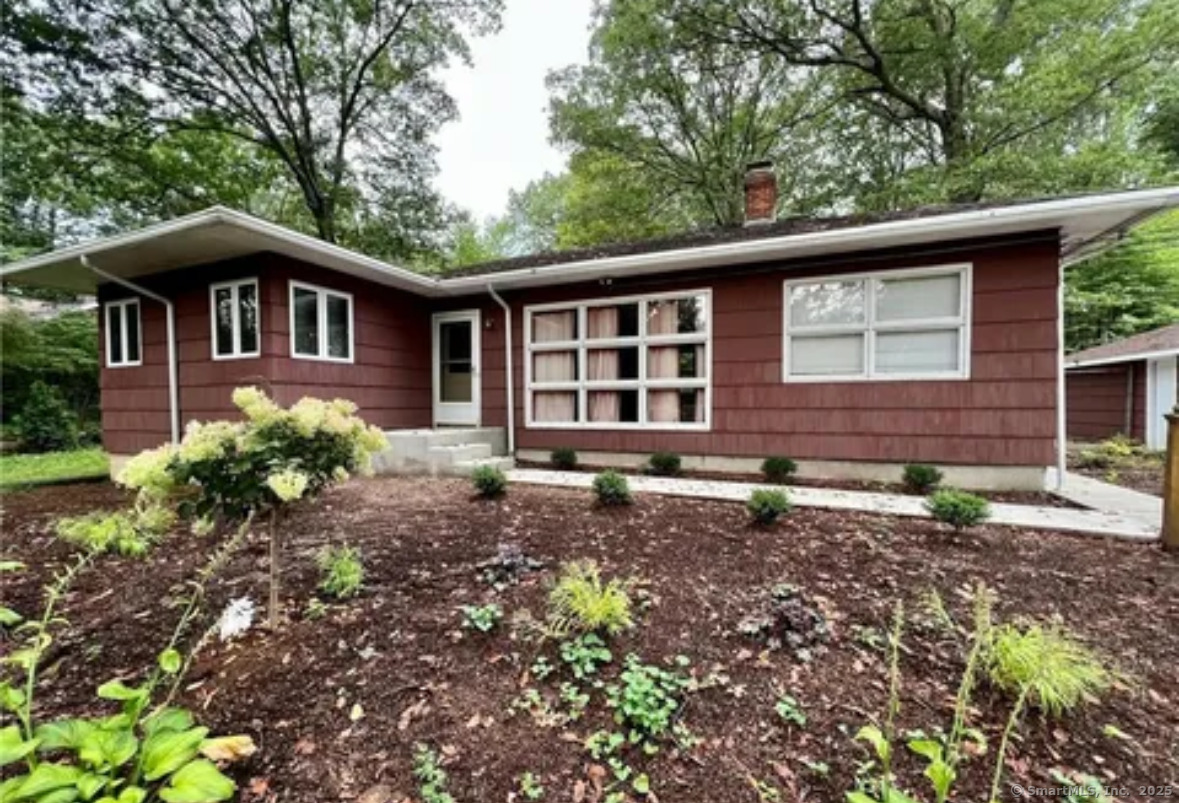 a front view of a house with garden