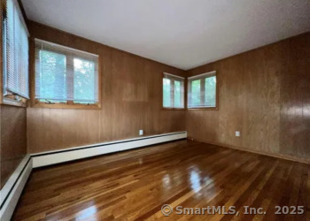 958 Dunbar Hill Road Hamden, CT 06514 - Photo 14 of 22 a view of an empty room with a window and wooden floor