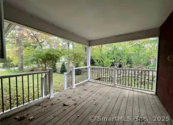 a balcony with wooden floor and outdoor space