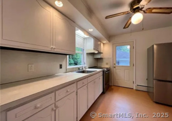 958 Dunbar Hill Road Hamden, CT 06514 - Photo 5 of 22 a kitchen with a refrigerator and a sink