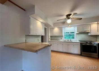 958 Dunbar Hill Road Hamden, CT 06514 - Photo 7 of 22 a kitchen with stainless steel appliances granite countertop a sink a stove and a granite counter tops