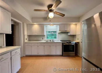 958 Dunbar Hill Road Hamden, CT 06514 - Photo 8 of 22 a kitchen with stainless steel appliances granite countertop a stove a sink and a refrigerator