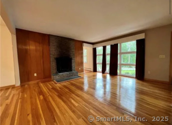 958 Dunbar Hill Road Hamden, CT 06514 - Photo 10 of 22 a view of an empty room with wooden floor and a window
