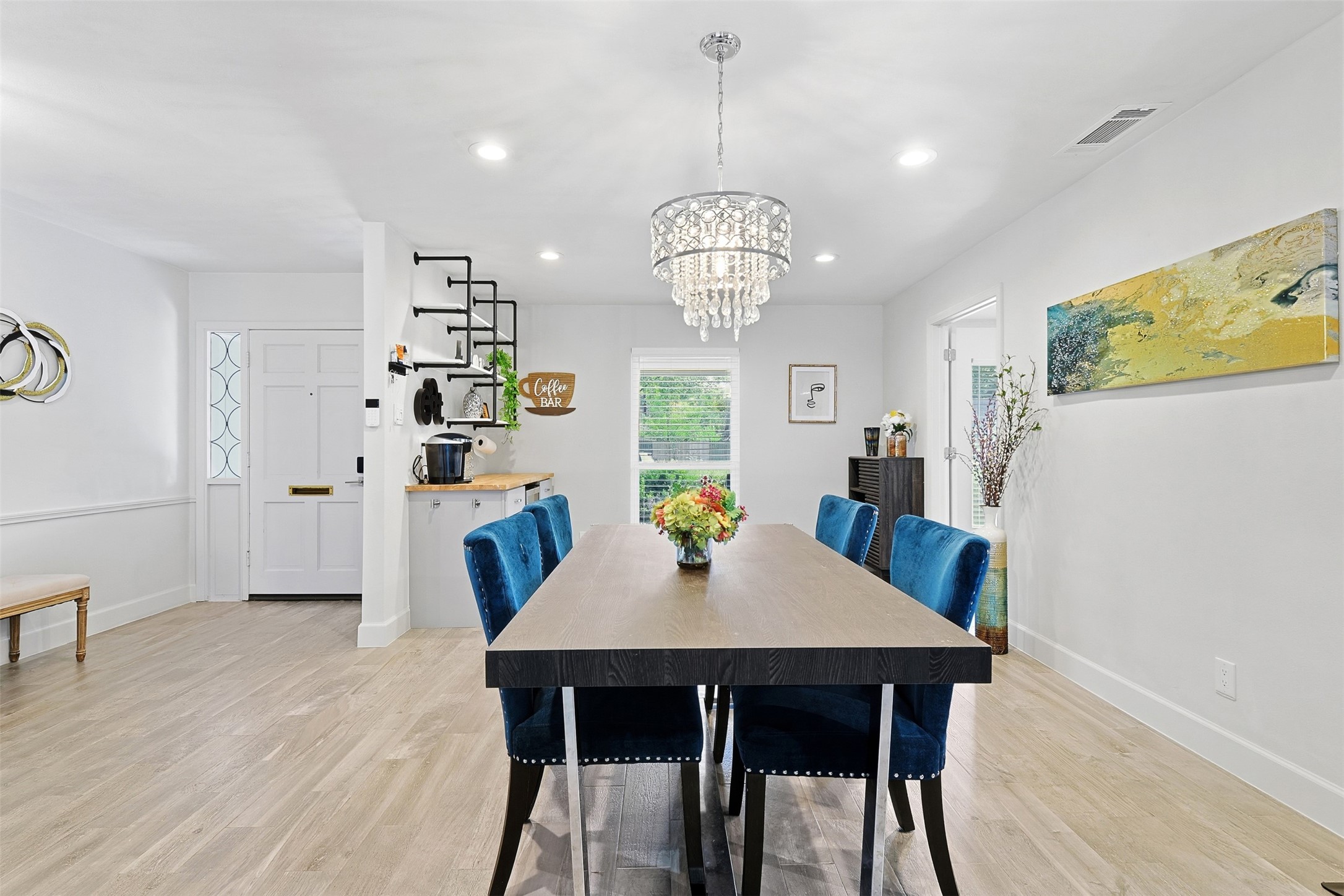 5218 Imogene Street Houston, TX 77096 - Photo 8 of 32 a view of a dining room with furniture a chandelier and wooden floor