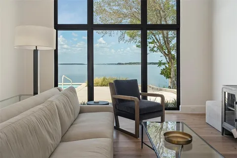 a living room with furniture and a floor to ceiling window