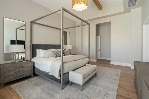 a bedroom with a bed and a mirror