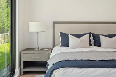 a bedroom with a bed and a night stand