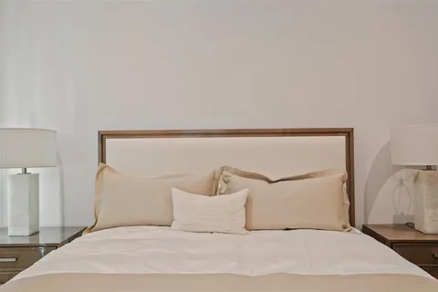 a bedroom with a white bed and pillows