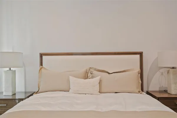 a bedroom with a white bed and pillows