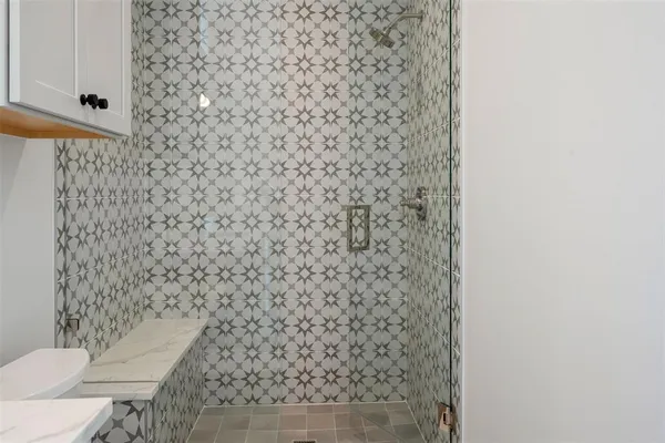 a bathroom with a toilet and a shower curtain