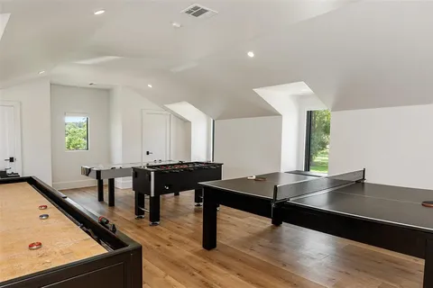 a living room with table chairs and a window