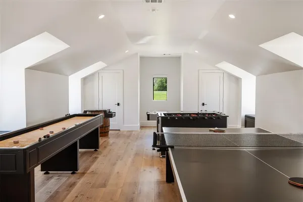 a kitchen with a stove and a wooden floor