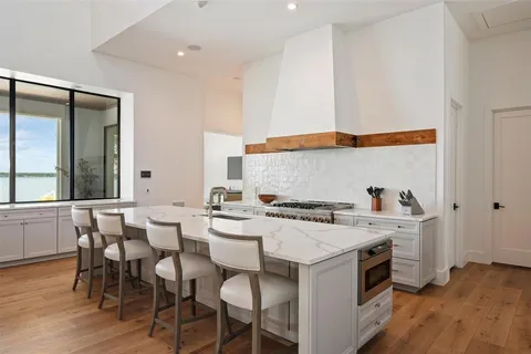 a kitchen with a sink and chairs