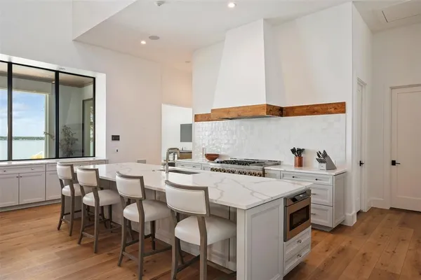 a kitchen with a sink and chairs