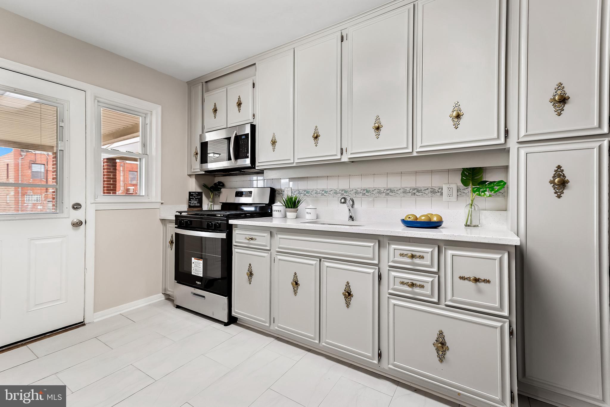 7259 Stratton Way Baltimore, MD 21224 - Photo 8 of 29 Original wood cabinets with new painted finish.