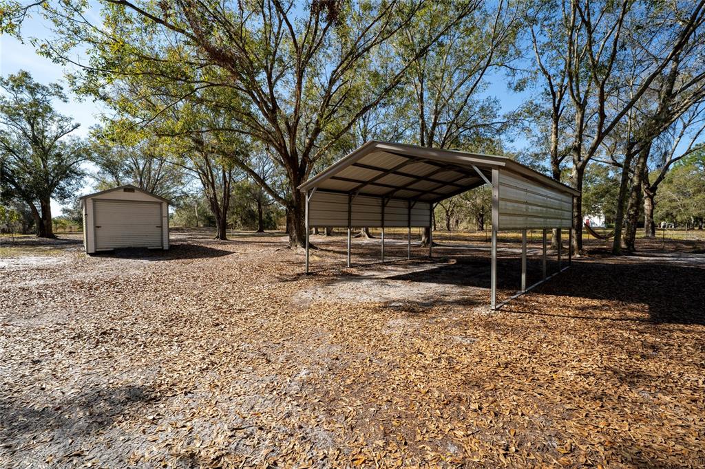 915 Keen Road, Unit 915 Frostproof, FL 33843 - Photo 12 of 53 a view of house with backyard and tree