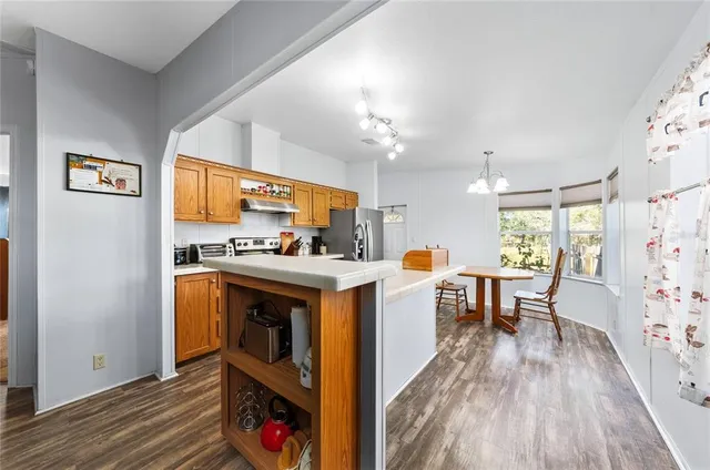 a kitchen with a stove and a refrigerator