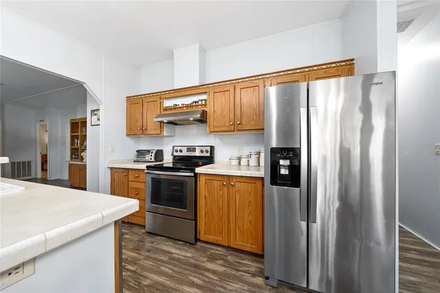 a room with furniture and view of kitchen