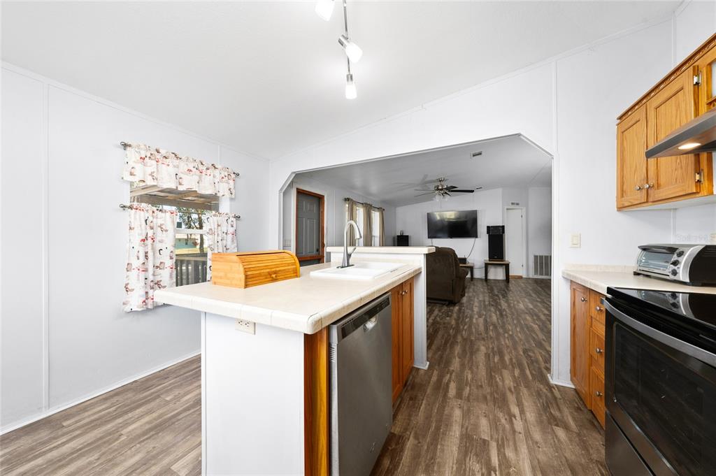 915 Keen Road, Unit 915 Frostproof, FL 33843 - Photo 41 of 53 a kitchen with a stove and a refrigerator