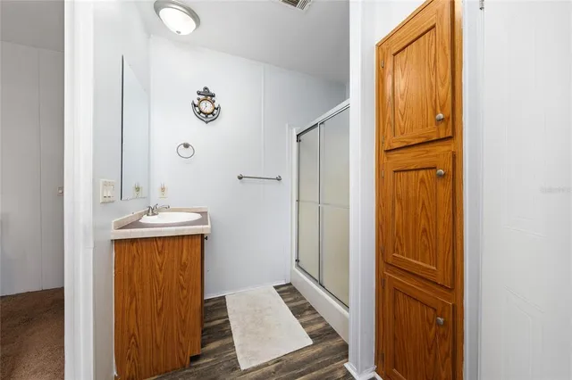 a bedroom with a bed and a lamp on the dresser