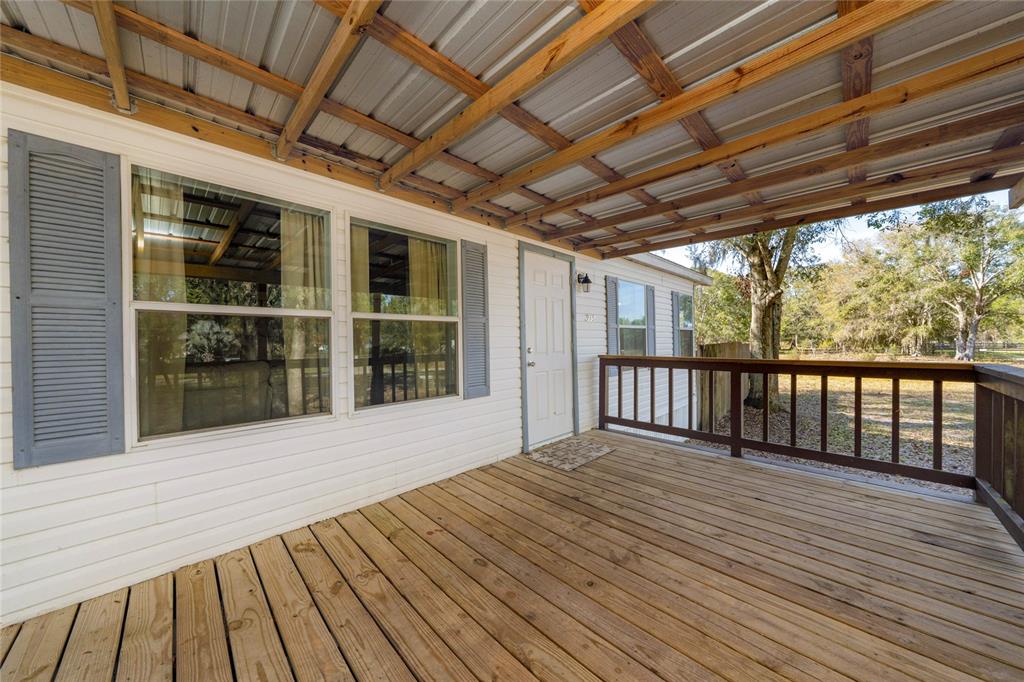 915 Keen Road, Unit 915 Frostproof, FL 33843 - Photo 5 of 53 a view of backyard with wooden deck