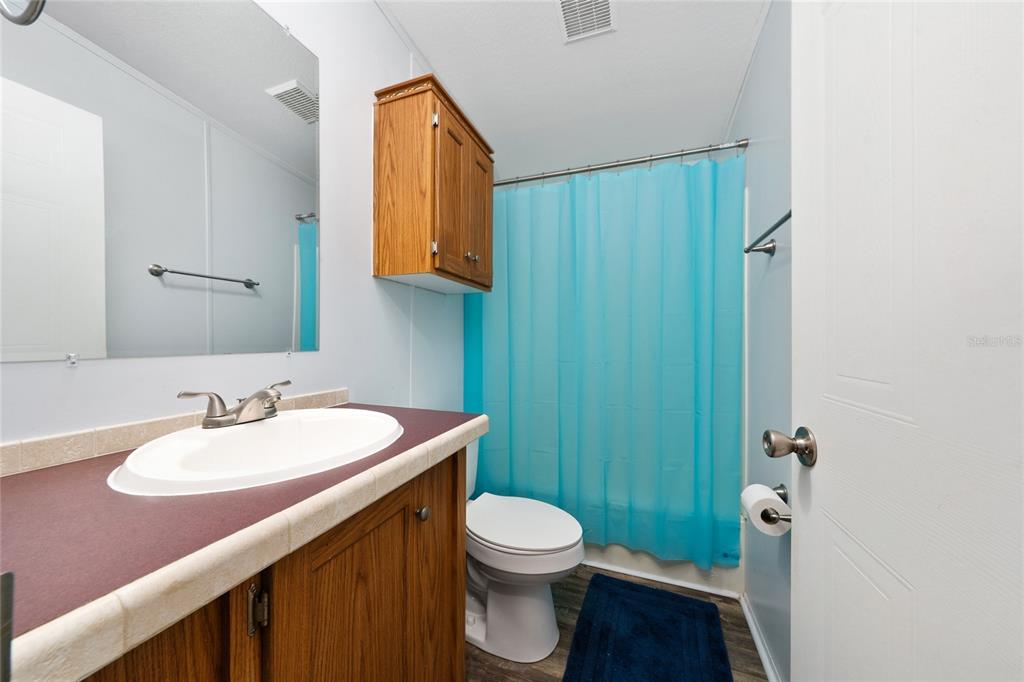 915 Keen Road, Unit 915 Frostproof, FL 33843 - Photo 53 of 53 a bathroom with a toilet a sink a mirror and vanity