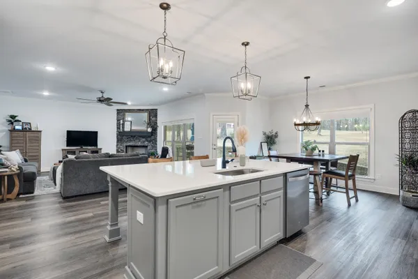a large kitchen with a table and chairs